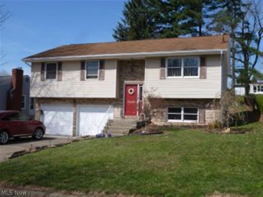 Very cute split entry home with 3 bedrooms and 1 1/2 baths.  Two car heated and air conditioned garage in basement.  Newer flooring in kitchen and living areas.  Large family room with a wall of kitchen cabinets. Covered back deck overlooking a fenced in back yard.