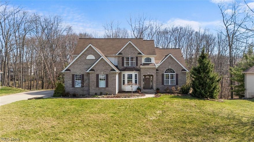 Enjoy the conveniences of neighborhood living while feeling tucked away in your own private retreat. This beautifully designed 4-bedroom, 4.5-bath colonial offers exceptional space & one-of-a-kind outdoor living. Welcome into the expansive foyer featuring hardwood flooring. 1st floor features highly desirable main level owner’s suite & an open-concept layout. Custom built kitchen boasts an island, rich hardwood cabinetry, granite counters, wine rack/china cabinet & eating area. The great room is sure to be the focal point, providing a vaulted ceiling, skylights, gas fireplace with stone accents & a stunning wall of windows. Formal dining room with a tray ceiling, ambiance lighting & bay window. Owners’ suite features vaulted ceilings, his/hers closets with closet organizers & on-suite bath with jetted tub & dual granite vanity. 1st floor also has a luxurious half bath and full laundry room with granite counters, sink, folding area & storage. Upstairs 3 generously sized bedrooms one of which has a dedicated bath. Additional Jack & Jill 2nd floor full bath. Finished walk-out lower level with 10.5ft of volume to the rafters will awe with all the incredible amenities including additional living space, full travertine wet bar with color changing ambiance lighting, theater/golf simulator area, workout room & more. Basement bath features live edge poplar vanity, floor to ceiling roman shower & more. Large storage room is set up for heated garage & basement floors. Step outside to enjoy ultimate relaxation in your private woodland retreat. Views of the gentle stream & serene waterfall feature from the 3 level stone backyard or elevated balcony off the kitchen. Extra deep & tall 3 car garage perfect for storing your watercrafts or sportscar. Lake Erie is minutes away! Enjoy many hiking trails & parks nearby. Located close to highways, shopping and restaurants. Near Beaver Park Marina & Copper Kettle Marina! Rare opportunity to own a truly unique home at an exceptional value!