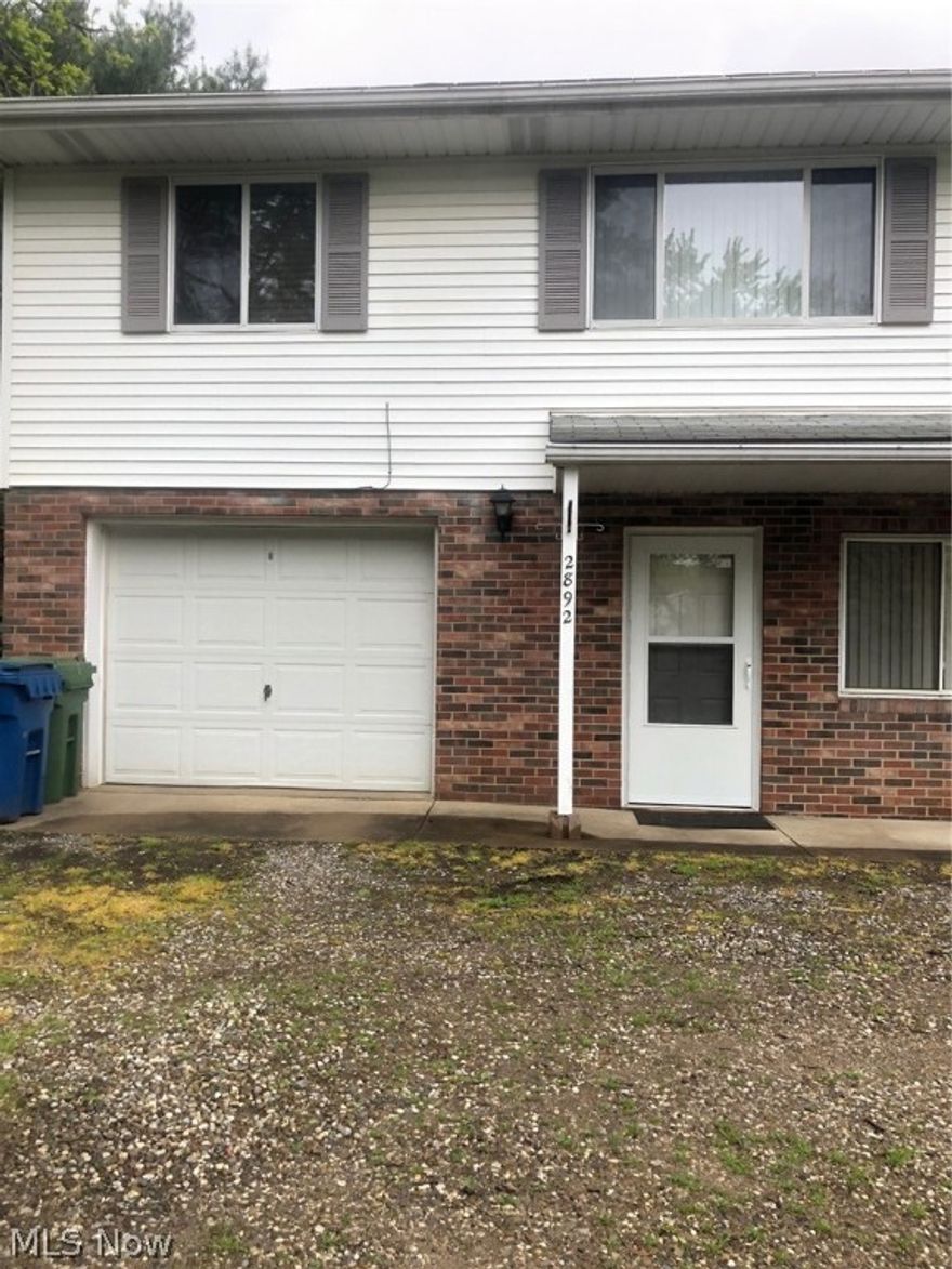 Located on a quiet street in Coventry close to Portage Lakes. Attached garage, with an extra living area and laundry room on the ground floor. Upper level has another living area, kitchen equipped with range and refrigerator, full bath and 2 bedrooms. Call us today for a showing!