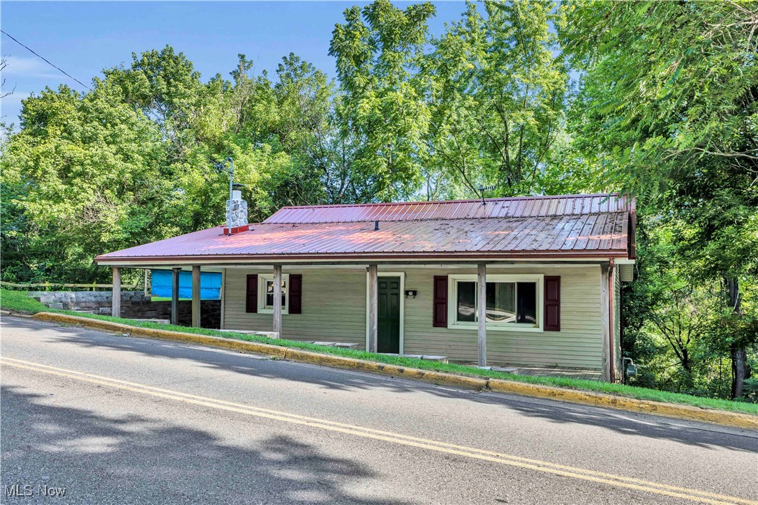 This beautifully updated single-family home sits on a picturesque corner lot at Canal Street and Blough, offering serene views of the Tuscarawas River and convenient access to the scenic Towpath Trail. Inside, you’ll find a unique and inviting floor plan that includes a walkout basement opening to a spacious wraparound deck—perfect for relaxing, entertaining, or simply enjoying the peaceful surroundings. The home has seen several recent improvements, including a brand new metal roof and hot water tank in 2024, along with stunning new hardwood flooring throughout much of the main level, adding warmth and character. The basement is partially remodeled and features a cozy wood-burning stove, a convenient half bath, and a dedicated laundry room, providing excellent additional living space and functionality. With its blend of charm, comfort, and location, this home offers a wonderful opportunity to enjoy both nature and convenience in one special property. Don’t miss this amazing opportunity and schedule your private showing today!