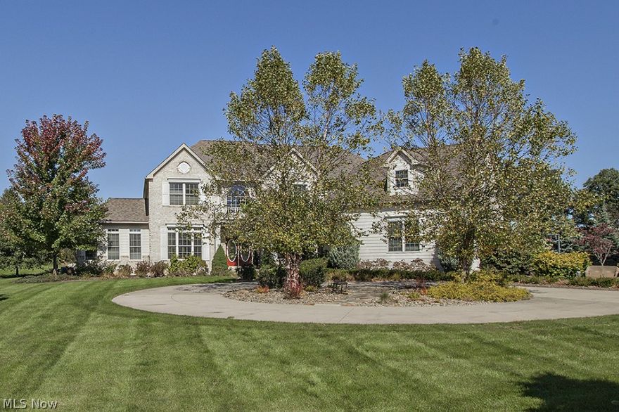 Dramatic presentation with circular driveway and mature landscaping. Impressive 2-story foyer opens to den & living room; great room features soaring stone fireplace, bar, & rear staircase. The over-sized chef's kitchen reveals large granite island with breakfast bar, stainless appliances, window seat, walk-in pantry, & access to 8 x 13 screened-in porch; 14 x 14 sun room brings nature inside. The glamorous master suite includes 10x10 walk-in closet and door to rear balcony; 2 additional bedrooms both with private baths plus a bonus room.  Unfinished 2,400 sq. ft. basement plumbed for 1/2 bath and wet bar. Multilevel patio with wonderful private entertaining space, includes fire pit.