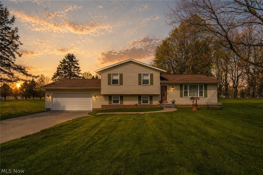 One-Owner Gem in a Sought-After School District! Lovingly maintained by its original owner, this spacious four-level split offers you one acre of land with FOUR bedrooms and THREE baths. From the moment you arrive, the newer cement driveway and turnaround make a strong first impression. Step inside to a welcoming front entry and discover a bright, open living room bathed in natural light from oversized windows. The dining room flows seamlessly to a recently refinished Trex deck with vinyl railings, creating an ideal indoor-outdoor living experience. The eat-in kitchen is in excellent original condition, featuring a range, microwave, refrigerator, and dishwasher — all replaced within the last five years — making it move-in ready while leaving room to personalize to your taste. Upstairs, three comfortable bedrooms offer restful retreats, including a primary suite with a private en suite bath. A large double-vanity hall bath serves the additional bedrooms. Head down to the lower level and discover one of this home's standout features — a warm and inviting family room anchored by a floor-to-ceiling brick wall with a gas fireplace and mantle. Newer carpet adds a fresh, polished feel to this already lovely space. Also on this level is a private guest suite complete with an egress window, closet, and a full bath with a walk-in shower — perfect for overnight guests, or extended family. The unfinished basement is clean, dry, and well-equipped. Major mechanicals — including the furnace, A/C (2020) — have been updated, giving you peace of mind. Outside, the whole-house Generac generator ensures you're never left in the dark, while gutter guards, vinyl siding, and a roof replaced around 2020 mean the big-ticket exterior items are already taken care of. The two-car garage offers storage and a door to the backyard, where a shed awaits. Plus, the home is right down the road from US-62, offering you easy access to highways and amenities. Schedule your showing today!
