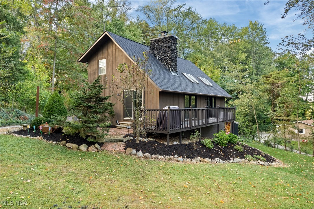 Stop what you're doing and schedule a showing of this incredible, one of a kind, home- it won't last long! First floor has 2 story great room with wood burning fireplace and doors to exterior deck, dining room with additional doors to outdoor patio, updated kitchen, half bathroom and bedroom, currently used as an office. Second floor has 2 more spacious bedrooms and full bathroom. Lower level has laundry room and storage area. There is also a 2 car garage, extra parking areas and shed, as well as a wood shed. This home has so many updates, all you need to do is move in: furnace/ac: 2017; water softener 2016; windows 2016; skylights and blinds 2024; new garage door 2024; roof 2018; retaining wall and extra parking area 2020; shed 2021