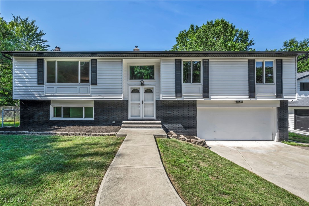 Stunning, renovated 4-bed, 3-bath home at the end of a serene cul-de-sac! Enjoy luxury vinyl flooring, brand-new carpeting in all four bedrooms, and a fresh coat of paint throughout for a modern, crisp look. The gourmet kitchen dazzles with white and black shaker-style cabinets featuring soft-close technology, stainless steel appliances, and a spacious island all covered by quartz countertops making it a great space to entertain. All three bathrooms, including two full baths, are beautifully updated, with one in the primary suite. The downstairs recreation room, complete with a cozy wood burning fireplace, is perfect for entertaining or family fun walks out to a lower level patio and the amazing back yard. Relax on the second-floor deck also overlooking the generous fenced in backyard, situated right off the dining room. A new roof and gutter system ensure worry-free living. new sliding doors to the outside have also been installed. This move-in-ready gem blends style and comfort in a prime location—schedule your showing today