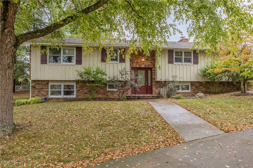 This is the first time this home has ever been offered on the market, and it is one you do not want to miss. Tucked away on a quiet cul-de-sac in Nimishillen Township with Louisville Schools, this bi-level brick home sits on over half an acre and has been carefully maintained since 1976. Inside you will find three bedrooms, two full baths, and inviting details throughout, including granite countertops and updated cabinetry in both the kitchen and bathrooms. The warmth of wood flooring carries through the main living spaces, giving the home a timeless feel. The lower level features a family room anchored by a fireplace and a beautifully tiled shower that adds a modern touch. Step into the fully finished sunroom, a true bonus living space that lets you relax and entertain year-round while overlooking the large lot. For those who need space to work or create, the property includes a massive 24x48 steel-sided and steel-roofed wood shop. Outfitted with LED lighting, steel work tables that will stay, a garage bay, wood burning furnace, and its own alarm system, this shop is as functional as it is impressive. It is truly a versatile space for hobbies, projects, or storage. Back at the house, the attached garage adds convenience and style, finished with a Nature Stone floor and newer garage doors for peace of mind. With its thoughtful updates, long-term care, and a location that offers both quiet living and excellent schools, this home is a rare find. Do not miss your chance to make it yours.
