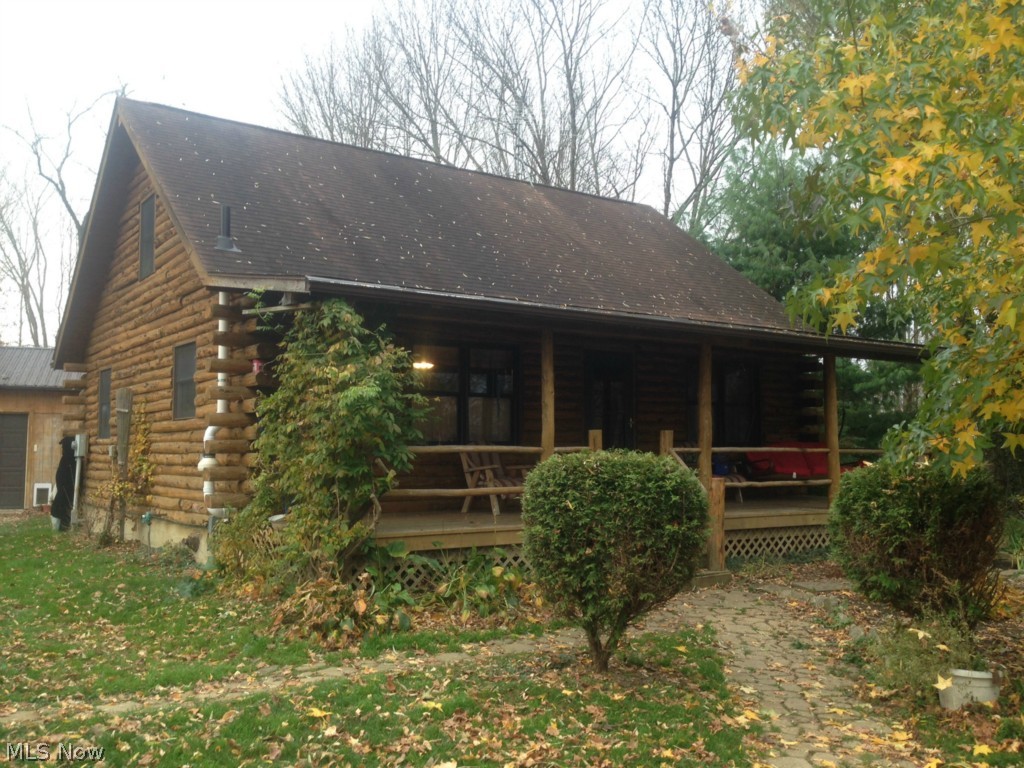 Fairview log home with log interior on 5.3 wooded acres. Vaulted ceilings in the living room, open to the kitchen and dining area. 1st floor bedroom and bath. Loft and large master bedroom on second floor with dual closets. Full, finished basement has nice family room, laundry area with storage, and 2 bedrooms with insulated floors. High efficiency furnace. 24x32 1+ car garage with shop area on one side, work bench, electric, drain, and wall heater.