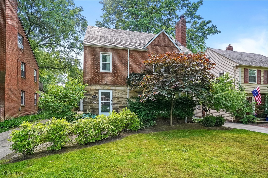University Hts Brick & Stone Colonial with Slate Roof in a wonderful location with finished third floor. Tiled Entry opens to the Large Living Room with oversized windows, Gas Fireplace with marble hearth, coved ceiling accent and archways opens to the Dining Room with hardwood floors flowing through the rooms. Breakfast Bar added bonus seating between the Dining Room into the Remodeled Kitchen and a perfect place to enjoy your morning coffee. Bright White cabinets, Granite countertops, SS Appliances including Gas Stove, Backsplash accents, Deep SS Sink, Eating Area and laminate flooring complete this beautiful room. Bonus First floor room perfect for a home office, playroom, or Reading nook leads to the Back with deck overlooking the expansive privacy fenced back yard. First floor half bath and storage areas help complete the first floor. Head upstairs for more hardwood flooring that runs through all three bedrooms with generous closet spaces. Gorgeous Remodeled Full Bathroom features hexagon tiled flooring, oversized vanity with granite countertop, tiled walk in shower and additional tub with shower and surround. Plus third finished floor can be the primary bedroom, amazing teen suite or art studio with access to walk in attic space, hardwood floor, closet space and storage. Lower level offers a finished recreation room with wood burning fireplace, glass block windows and room to expand. Laundry area already has the washer and dryer and more storage options. Home warranty offered. Fabulous location close to shopping, restaurants, medical, parks, and so much more. Being sold as-is. Point of sale to be assumed by buyer. Perfect combination of updates, features and opportunity to bring in your decorating ideas.