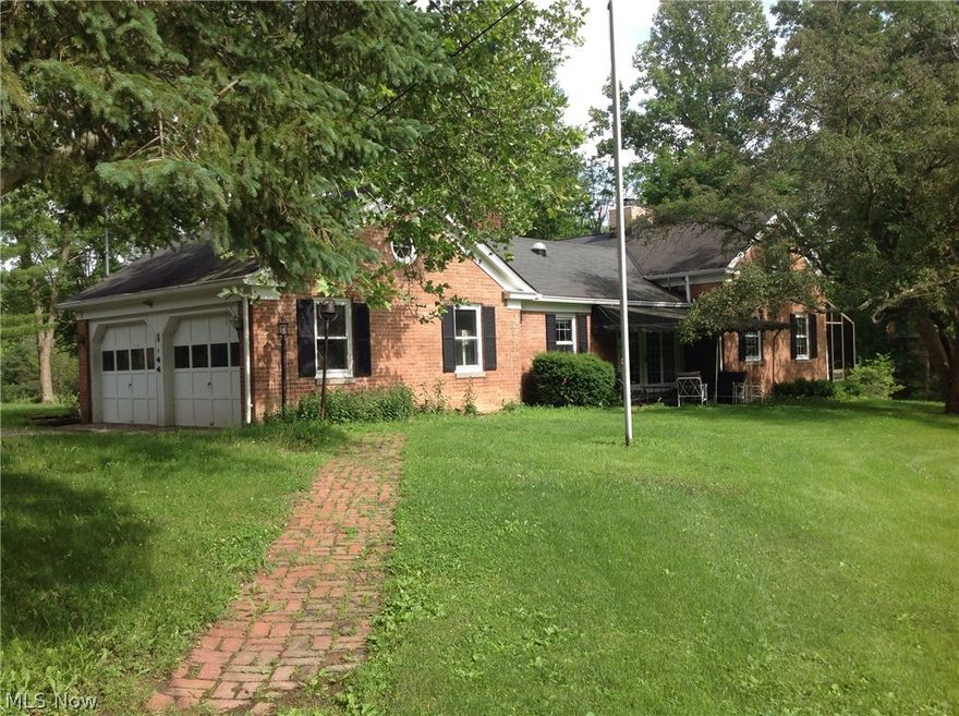 If you've been looking for a serene country home with over 7 acres of rolling hills & trees, within minutes of city conveniences, then your search is over! This  3 bedroom, 3 bath, brick ranch/bungalow is tucked back away from the road, nestled among the trees and pond, where you can watch the wildlife & enjoy the natural beauty from any window in the house!  The large  1st floor Master Bedroom has built in shelves, 3 closets, ceiling fan and plenty of windows! Dining room & spacious Great room each have a fireplace to enjoy on those those chilly winter nights. From the Great room step down into the Sun Room to relax with your morning coffee and enjoy the view. Freshly painted and newer carpet throughout.  This property has a huge 1680 sq. ft. Century Barn with a loft built in 1838! There are also 2 additional outbuildings, that would be great for car buffs, farm animals, "toys" or just extra storage!
Property is located in Brunswick Hills and is in the Brunswick City school district