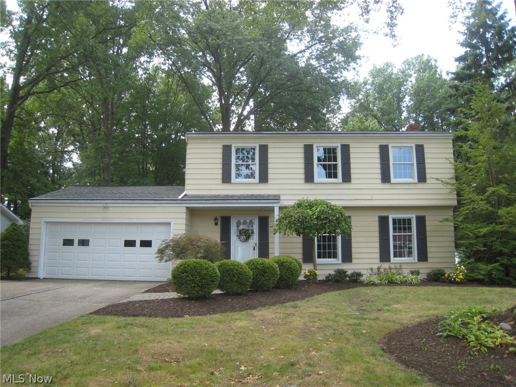 As you pull up, you will notice the professionally landscaped yard with manicured beds of blooming perennials that surround the home and property. The foyer entry welcomes you with recently installed muted gray subway tiles. The updated half bath is conveniently located here. To the right is the formal living room enhanced with beautiful hardwood floors that flow throughout the entire home and white crown molding and wood trim. All the newer windows have custom shades and white trim, too. The dining room is open to the spacious kitchen with an island, upgraded appliances and custom cabinetry. The double pocket doors can close off the dining room for a more formal dinner and a paned glass door to the outside cobblestone patios and composite deck. The wall between the kitchen and family room is opened up and creates a great entertainment or family space across the rear of the house. An addition was added with a possible 5th bedroom or office and full bath with step in double shower