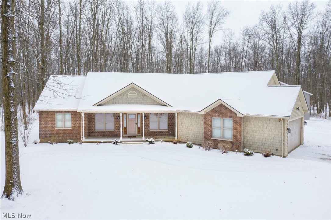 You really CAN have it all! Not just a home, but a private, wooded sanctuary! The 5.88 acre property includes an immaculate home and a separate 2,800 sq foot multipurpose space/workshop/storage complex! Charming lampposts line the long driveway to this move-in-ready, custom-built home full of must-see features! Endless possibilities exist for the additional building! You simply MUST see it all to turn your imagination into reality!