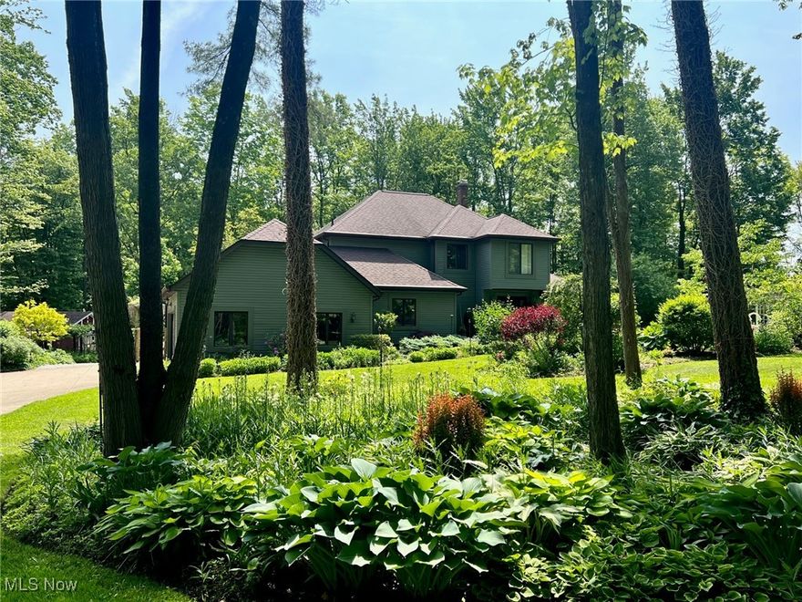 WELCOME HOME to this Beautifully Updated Colonial nestled on nearly 7 Private Wooded Acres! This spacious home offers approx 3000 sqft of living space with 4 Bedrooms & 2.5 Baths and plenty of room to grow. Main level living includes foyer entrance with hardwood floors through to Dining Room. Completely remodeled and well-appointed Kitchen with abundance of cabinetry, granite counters, large center island breakfast bar, custom pantry, stainless steel appliances include GE Cafe 6-burner professional range, Breakfast Room & deck access. Warm and inviting Family Room with coffered ceiling, wood burning stove and access to patio. 1st floor Home Office/Library with built-in bookcases. All 4 Bedrooms on second floor include LVT flooring throughout, large Master Bedroom with custom closet system and updated Master full bath. 3 additional bedrooms with updated full bath to share. 1st floor laundry room with cabinetry & half bath. Many major updates since 2024 include: New furnace and A/C heat pump, Honeywell humidifier, 200 amp electrical panel, whole house generator, new water softener, iron filter, reverse osmosis system, sump pump & new septic system. Vinyl siding 2021. Enjoy peaceful views out every window, this home is truly a nature lovers retreat and ideal for the homesteader. These private and secluded park-like acres are surrounded by mature trees, landscaped with an abundance of perennial gardens, flower beds and fruit trees with raised garden beds & greenhouse, multiple outbuildings, stocked pond plus many wooded acres to add hiking or ATV trails. Newly fenced-in pet area plus the front 1.5 acres is fenced with 8 ft chain link & electric entry gate. Relax or entertain on the expansive deck & brick patio with pergola, firepit & hot tub. 2+car attached garage, 40x24 2-story Barn, 24x16 Polebarn with new siding & barn door, storage/garden shed. Must tour to appreciate all this home has to offer inside & out! Chardon Schools.