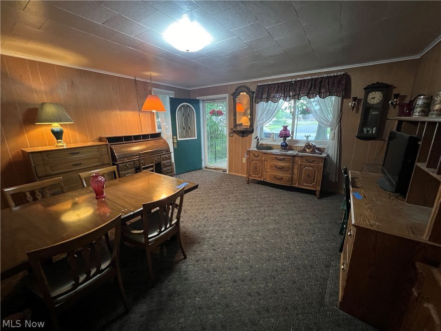 Cozy 3 bedroom 2 bath vinyl sided home!  Wood burning fireplace in the living room.  Main floor master bedroom features French doors to the back yard.  Freshly painted kitchen with brushed nickel hardware includes range and refrigerator.  2.5 car detached garage includes car lift, exclude chain hoist.  20 X 10 storage barn with electric.  Large level lot.