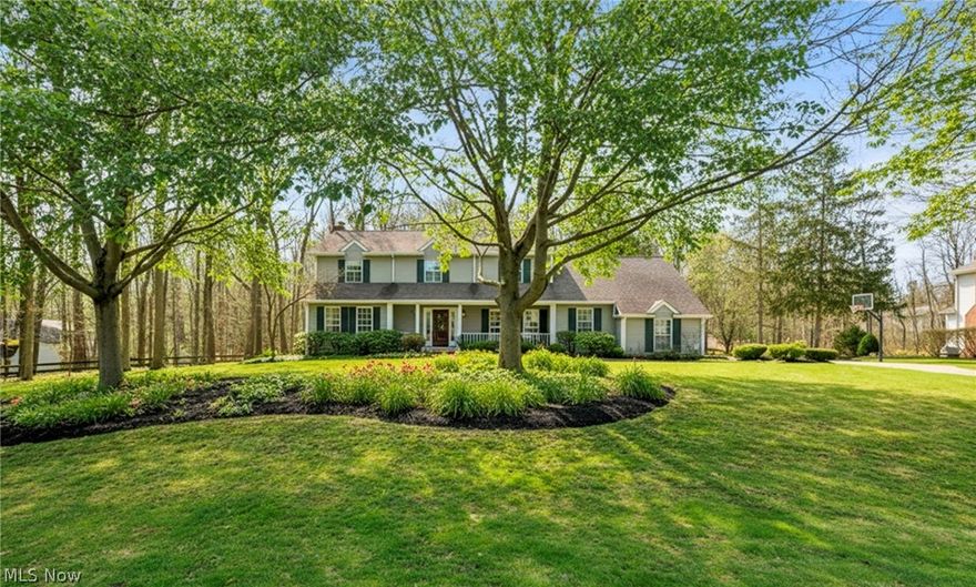 Welcome to a truly one-of-a-kind, custom-built home that seamlessly blends timeless quality with a full Knez addition. Nestled on over a half-acre in Concord’s Arbor Glen, this 4-bedroom, 3.5-bath Colonial offers an architectural flow and level of privacy that is simply unmatched.

Begin on the inviting front porch, leading into a bright foyer. To your left and right, the formal living and dining rooms both showcase crisp crown molding, with the living room tucked behind elegant French doors. The heart of the home is the chef’s kitchen, featuring updated natural cherry cabinetry, granite counters, and a huge center island perfect for gathering. This space flows into the show-stopping addition: a sun-drenched, vaulted Morning Room with panoramic views of the grounds. The main level also boasts a cozy family room with a gas fireplace and custom built-ins, a spacious laundry room with windows, a practical mudroom with side entry, and a rare, full guest bath.

Uniquely designed with two separate staircases, the home offers effortless transit between levels. The upper addition introduces a dedicated office with an architectural overlook into the Morning Room below—a workspace with incredible energy. The primary suite serves as a retreat, offering dual closets and a spa-like en-suite with a soaking tub and walk-in shower. Three additional generously sized bedrooms share a third full bathroom.

The lower level is a world of its own. The original basement houses a finished rec room with built-ins, a convenient half-bath, a workshop, and expansive storage with built-in shelving. The addition’s lower level reveals a secluded "man cave" or den with extra storage. Even the side-load garage is upgraded with a Nature Stone floor. Outside, discover a beautifully landscaped sanctuary with two patios and a Trex deck, all backing directly into a protected conservancy for permanent, wooded privacy. Located in the Mentor School District, this exceptional property is a rare find.