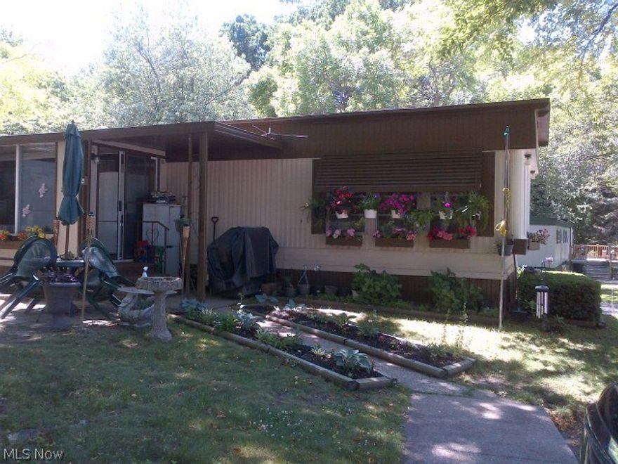 This single wide MFH has been recently refreshed with metal roof, hot water tank, awnings and a beautiful front bay
window, Furnace and Central Air aswell.  The landscaping is colorful and varied. This over 55 community is complete with wooded lots and a center
lake for your enjoyment. Make this one your summer home or stay year around.. either way its a hidden gem. Call
today for your tour.