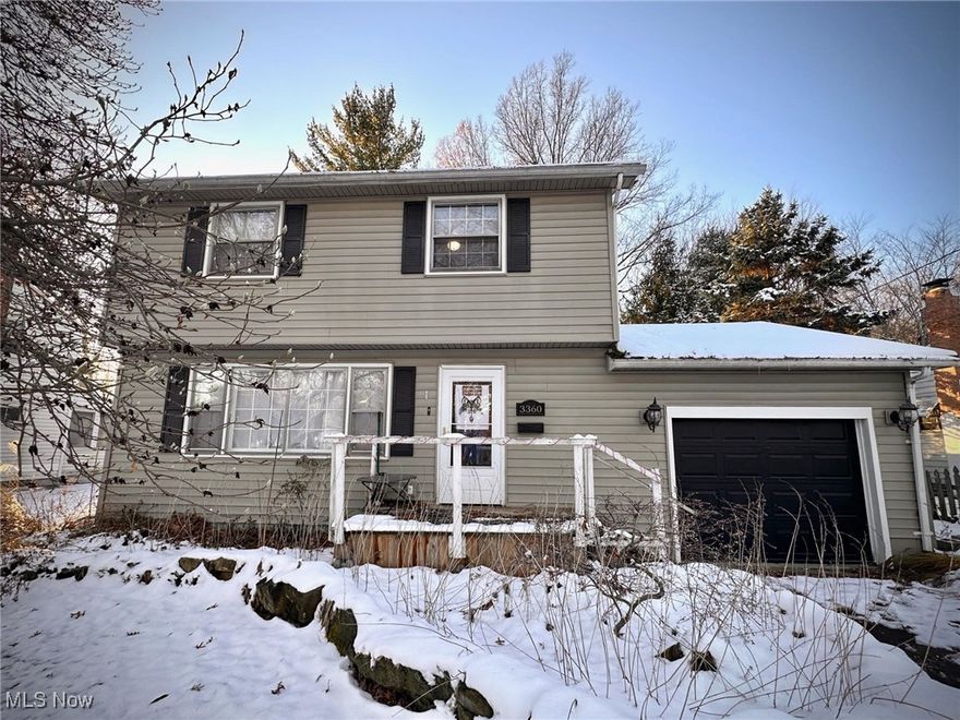 Austintown home featuring updates including updated laminate flooring throughout the first floor and a beautifully renovated kitchen with ample cabinet space, a stylish subway tile backsplash, a large single-bowl sink, and gold brass fixtures. Kitchen opens to a formal dining area with French-style doors leading to a back deck and a spacious backyard with storage shed. Upstairs offers three spacious bedrooms and an updated full bath, while the downstairs finished basement provides rec area, laundry, additional living space with two potential bedrooms.