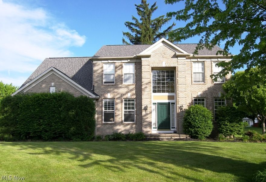 Stately brick front colonial built by Pulte Homes in the highly sought after Eaton Estates.  Beautifully landscaped, this house presents a two story foyer opening to the living room and dining room. Hardwood floors in the foyer, dining room, kitchen and eating area.  The spacious family room has a gas fireplace and opens to the great kitchen with granite countertops, a center island and eating bar as well as a stainless gas oven/range, dishwasher and microwave oven.  Wonderful views from the eating area in the kitchen with a sliding door to the oversized deck and backyard.   All bedrooms are on the second floor with the master suite featuring a walk in closet and spacious bath with double sinks, a soaking tub and separate shower.  The other three bedrooms and full bath are nicely sized.  Not to be missed is the finished lower level with a recreation room, a fitness area, a bedroom/craft room and full bath.  Roof installed in 2012.  Just move in and enjoy the amenities of the pool, play