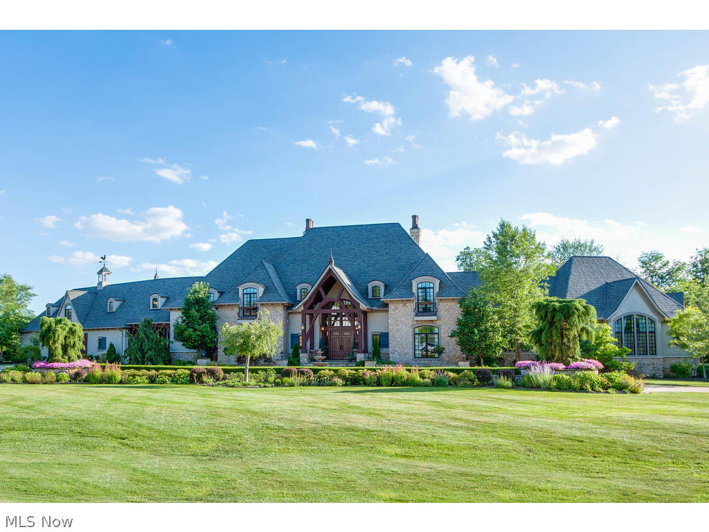 The Home You Have Been Waiting For in Bath Twp! 5 Bedrooms, 5.3 Baths, plus separate guest house with an additional bedroom, 1.5 baths & full kitchen. First time ever on the market! This stunning French Manor home lends itself to impressive entertaining, as well as practical everyday living. Gourmet kitchen with custom appliances opens to 2 story great room. First floor master suite with spa quality master bath (walk-in steam shower, claw foot tub), spacious master closet & granite coffee bar complete with sink, refrigerator & microwave. Executive office with FP. Dining room seats 18! Amazing views from the entire rear side of the home showcases the resort like backyard. 2nd floor features 3 En Suite bedrooms and a 500 sq/ft bonus room. Complete with every amenity for luxurious living, the finished walkout lower level offers media/theater room w/stadium seating, wine cellar, spa room, rec room w/ full bar and FP and an 1100 sq/ft workout studio or playroom. Retreat to your own RESORT in the private backyard! Landscape pool with water slide & waterfalls. Cabana & guest house with full kitchen, bedroom and 1.5 baths. Enjoy dining pool side at the outdoor dining room and entertain around the 2 story outdoor stone fireplace. This spectacular estate provides privacy within North Bath Estates but is minutes from shopping, schools & highways. Easy access to both Cleveland and Akron. High-tech security cameras throughout residence. Award winning Revere Schools.