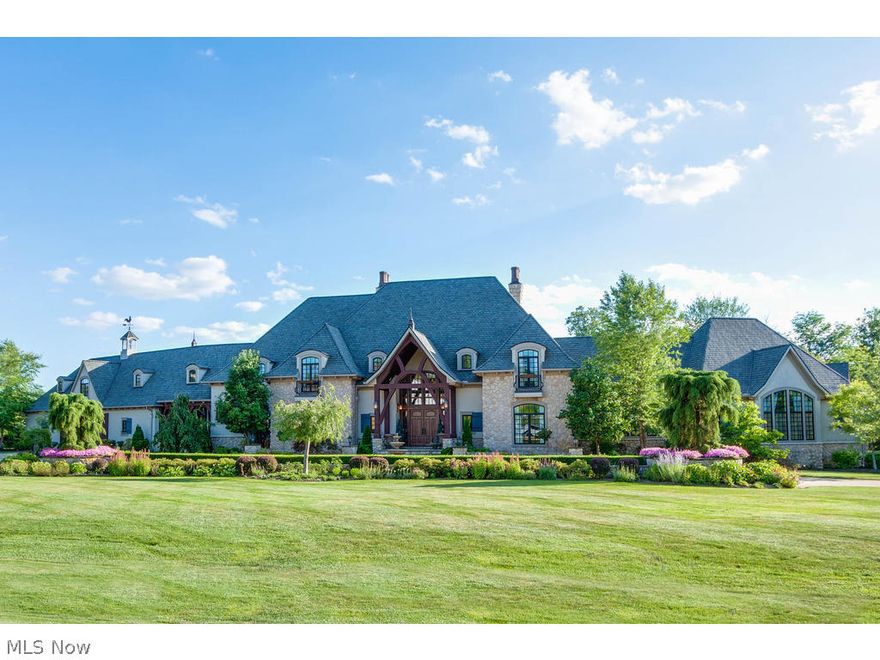 The Home You Have Been Waiting For in Bath Twp! 5 Bedrooms, 5.3 Baths, plus separate guest house with an additional bedroom, 1.5 baths & full kitchen. First time ever on the market! This stunning French Manor home lends itself to impressive entertaining, as well as practical everyday living.  Gourmet kitchen with custom appliances opens to 2 story great room. First floor master suite with spa quality master bath (walk-in steam shower, claw foot tub), spacious master closet & granite coffee bar complete with sink, refrigerator & microwave. Executive office with FP.  Dining room seats 18! Amazing views from the entire rear side of the home showcases the resort like backyard.  2nd floor features 3 En Suite bedrooms and a 500 sq/ft bonus room.  Complete with every amenity for luxurious living, the finished walkout lower level offers media/theater room w/stadium seating, wine cellar, spa room, rec room w/ full bar and FP and an 1100 sq/ft workout studio or playroom. Retreat to your own RESORT in the private backyard! Landscape pool with water slide & waterfalls. Cabana & guest house with full kitchen, bedroom and 1.5 baths. Enjoy dining pool side at the outdoor dining room and entertain around the 2 story outdoor stone fireplace. This spectacular estate provides privacy within North Bath Estates but is minutes from shopping, schools & highways. Easy access to both Cleveland and Akron. High-tech security cameras throughout residence. Award winning Revere Schools.