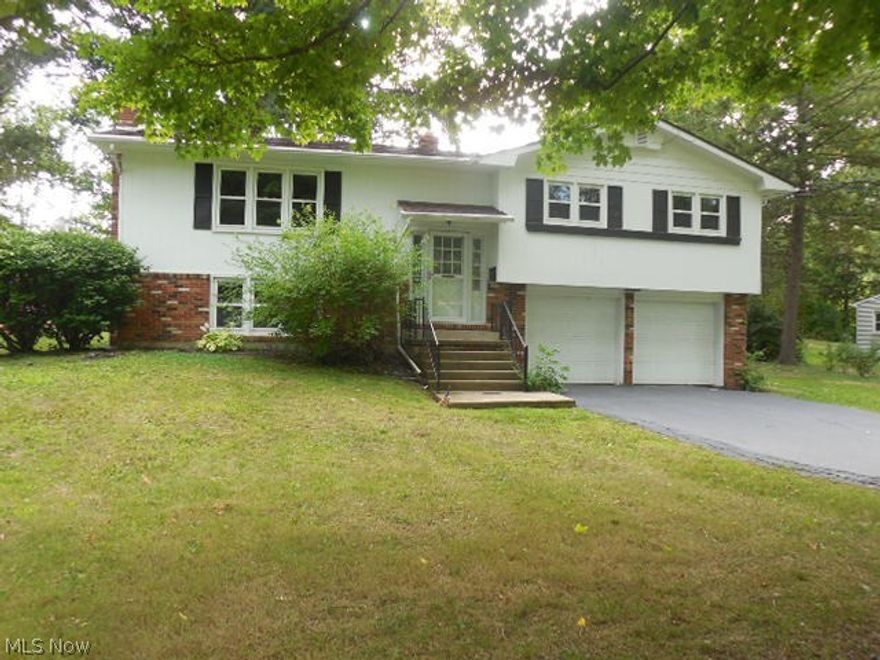 Looking for a great bilevel home in Canfield with a backyard that goes into Greasel Park? Well, this may be the one for you! Walking in, you may note the home was just freshly painted 8/2016 in neutral tones and brand new carpeting 8/2016 has been installed throughout! The living room is spacious and opens to the formal dining room. The kitchen comes with appliances, has an eat in space and updated vinyl flooring, and A Door leads to an upper level deck to view the backyard!   All three bedrooms have great natural lighting and large closets. There is an upper level full bath with ceramic tile and a linen closet. The laundry/utility area also holds a second toilet with a shower. Washer & dryer are negotiable. This home has a spacious yard. There is a double wide driveway that leads to the attached two car garage with auto door openers and additional space for storage. Central Air. Vinyl Windows. Yes, you may want to make some updates but this home has so much potential!