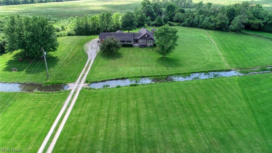 PROPERTY PRICED TO SELL, BELOW APPRAISED VALUE!!    Welcome to this beautiful 4-bedroom 3.5 bath ranch style home. Situated on 2.88 acres within walking distance to Buckeye Lake and local amenities.  With 2400+ sq. ft of living space this house was redesigned and remodeled in 2021 from a duplex into one large residence.  Boasting updated bedrooms and bathrooms with a more modern look, while the open floor plan kitchen and living room kept a more rustic look. Having the uniqueness of a garage in the front and the back allows plenty of space for two cars to be parked indoors or have a designated man cave adding additional living space. The large front porch opens up into the expansive yard facing the east for beautiful sunrise views and the back patio off of the master bedroom allows you to enjoy breath taking sunsets and large gatherings with plenty of seclusion. Seller is giving an allowance to have the home stained or painted, up to $5000.