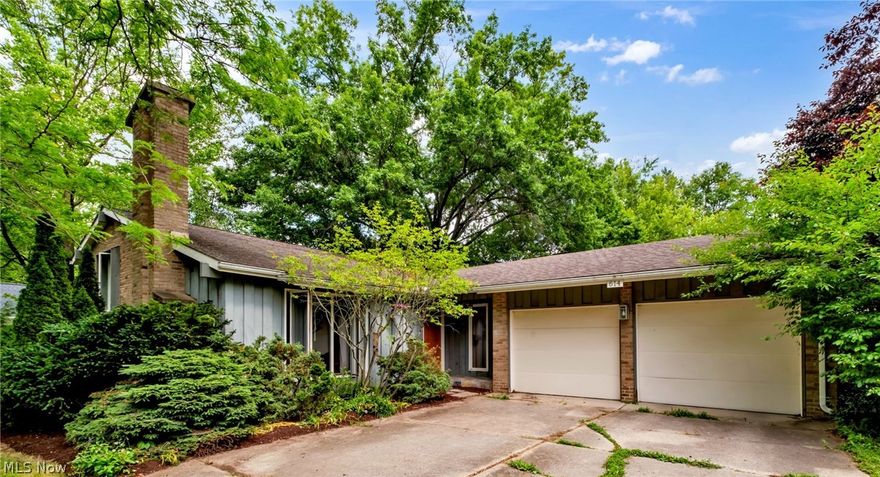 Lovely split level home in a fantastic location in Oberlin!  The living room has a brick wood burning fireplace with built in shelves on either side.  Additional features on the first floor include vaulted ceilings in the living and dining rooms, open shelving in the kitchen, sliding glass doors to the back yard from both the kitchen and dining room.  Additional  living space in the lower level which can be used as a family room, office space, workout area, etc.  The lower level also features a half bath and a huge laundry/utility room with loads of storage.  The second story has 3 good sized bedrooms and a full bathroom.  The 2-car garage is equipped with an outlet for an electric vehicle.  This home is in a quiet/secluded neighborhood; but just minutes from downtown and campus.  Great lot showcasing  beautiful landscaping, lovely trees, and fully fenced backyard.   The park-like backyard has many features including a deck, patio, a grass/lawn area, flower garden, shed, and wooded area with a cabana. So much outdoor space to enjoy here!  Additionally, this home is walking distance to the Pyle Road Nature Preserve, the Oberlin Arboretum, as well as the Oberlin Bike Trail.  Don't miss your chance to see all this property has to offer!
