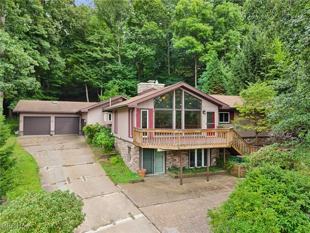 Welcome home to this custom-built lake-view home in the desirable gated community of Lake Mohawk! The lake lifestyle is calling to you with this home's wonderful mix of contemporary upgrades, serene privacy, huge garage spaces, a breathtaking view of the lake, and a finished walkout basement! The extra-large family room features hardwood floors, beamed vaulted ceilings, a gas fireplace, and killer views of the lake. Make your way into the eat-in kitchen, which is a chef's dream. Featuring custom-built soft-close cabinetry, granite countertops, custom backsplash, beamed vaulted ceilings, a convenient island, dedicated dining space, and a huge walk-in pantry. Down the hall, you'll find the wonderful full bathroom, recently updated, as well as the four large bedrooms, each with LVP flooring and large closets, and the wonderful master suite! The master bedroom is the largest, and features two closets and a full bathroom. Downstairs, the huge, finished, walk-out basement is the perfect compliment to the main floor. Featuring a recreation room, full bathroom, laundry room, multiple bonus rooms/office spaces/bedrooms, all with new flooring! Take the party outside, where you will enjoy entertaining in the super-private backyard area, featuring a Trex deck, patio, and above-ground pool. Like garages? This home features a heated attached 2+ car garage, as well as another heated attached 1200+ square foot, 6 car garage! Finally, the lakeview from the front deck is unbeatable, truly one of a kind. Lake Mohawk is a private gated community with an unlimited horsepower 500-acre lake, 3 beaches, an executive 9-hole golf course with a separate membership, tennis/pickleball courts, clubhouse, and more! Call today for your private showing in order to make this home yours!