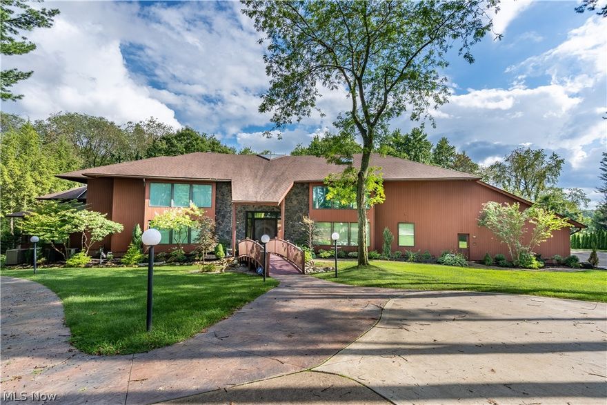 Tucked away in Thistlehill Village, sits a 13,000 sqft, 5-bedroom, 7-bathroom charmer, in a cul de sac street. A neatly manicured lawn, and a paved walkway leads to the double front doors of this unique Contemporary/Modern home. The 37 foot grand foyer with marble floors opens up to a beamed ceiling and beautiful windows that overlook 2 acres. This quality built home also has a fountain that enhances the home's entrance with a LED lighting system. The kitchen offers a large center island, granite countertops, and stainless steel appliances. All rooms upstairs are generously sized, have carpet flooring throughout and include built in closets. The master bedroom has an oversized jacuzzi tub with marble flooring, a private library, fireplace, and a large walk in closet. This home also features an indoor pool with a retractable cover, a hot tub, and cedar beamed ceilings that all walk out to a beautiful deck. The finished lower level includes a dance floor, a wet bar, movie theatre, game room, workout area, and a full kitchen making it the perfect place to entertain. This home truly has it all. Schedule a showing today!