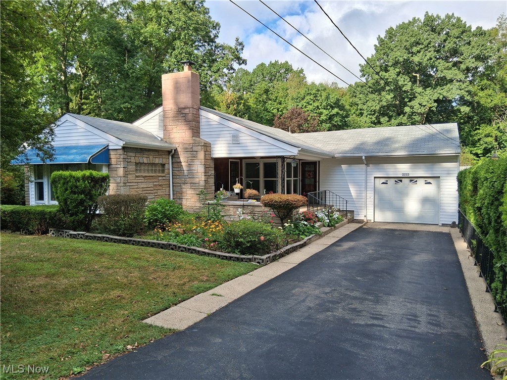 Excellent location to have 4 acres! Nice ranch home with open kitchen & eating area. Large living room w/fireplace. Lower level family room also has a fireplace. Walk-out basement in the back. Home has garages for 7 cars. Black top drive to all garages. Roof was new in 2020. Lot has lots of flower beds & garden, Property is more than 50% wooded, very scenic & great setting. Convenient location to everything.