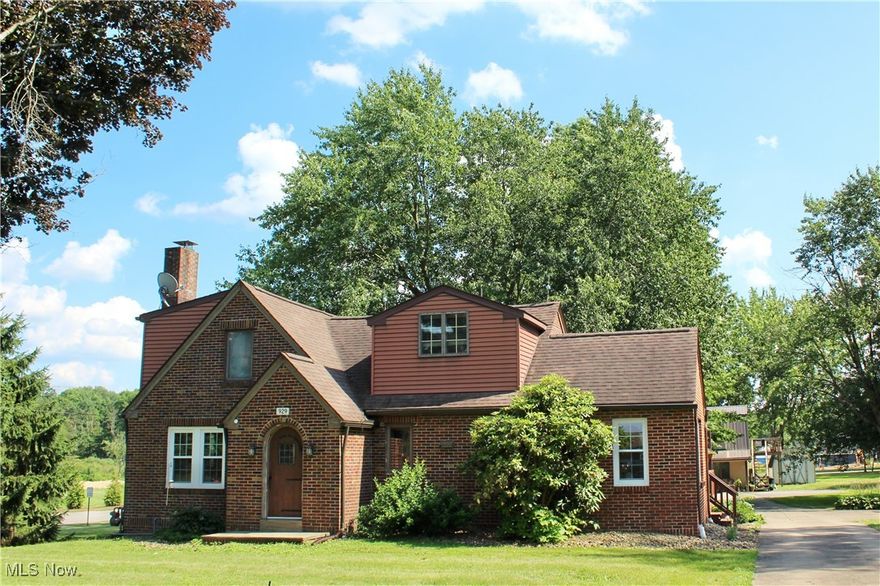 Beautiful Brick Home on an Acre with Bonus Two Bedroom Apartment! Welcome to this charming brick Cape Cod nestled on an acre in desirable Columbiana!  Step inside to a spacious living and dining area highlighted by a cozy fireplace, and a bright kitchen with a breakfast bar. The main floor includes a convenient bedroom and full bath with shower—perfect for guests or single-level living. Upstairs, you’ll find a large 23x13 primary bedroom with newer laminate flooring and generous closet space, a third bedroom, and another full bath with bathtub. The basement offers great bonus space, including a potential rec room, fruit cellar, laundry area, and more. Outside, enjoy the freshly stained two-tier deck, relaxing patio, and a beautifully maintained garden that’s ready for summer evenings or morning coffee. A standout feature is the two bedroom apartment located in the bonus outbuilding—offering a private living room, kitchen with appliances, two bedrooms, 1.5 bathrooms, and its own heated garage with workbench. Whether you need space for extended family, a hobby room, or a private retreat, this versatile setup delivers. Commercial C-4 Zoning allows for many possible uses with this property. Schedule your private showing today! (Back on Market due to Buyer's financing falling through. No fault of Sellers.)