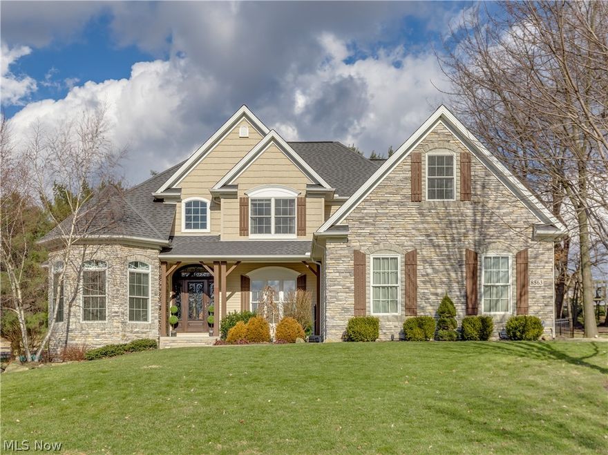 Stunning, uniquely designed home with first floor master suite in "Jackson's Gem" - Carrington Estates!  Gorgeous 2-story foyer entry with hardwood floors, leads you right into the beautiful great room with stone fireplace (gas logs), wide hallway with wet bar/wine rack, easy access to formal dining room with elegant columns and lighting.  You'll love the custom kitchen w/old world cabinets, farmhouse sink, granite counters, double door pantry, quality wide hickory hardwood floors., stainless steel appliances.  Eat-in kitchen area opens via glass french doors to sun room with cathedral ceiling where you can further entertain outside with custom deck, stamped patio, fire pit and iron fenced backyard, lined with mature trees.  Totally move in ready, partially finished basement with 5th bedroom, full bath, exercise room, play area and access to oversized 3-car garage.  Priced to sell and quality throughout!