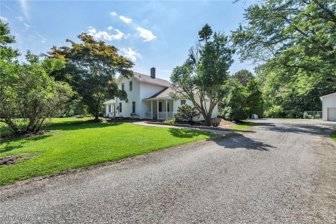 Welcome to this beautifully updated two story home on a sprawling picturesque lot with custom brick walkways, amazing porch and deck space. This rare property features over 2700 sf of living space with a 2 story over sized garage and a large outbuilding for additional storage. Entering the home, you will be greeted by a spacious gourmet kitchen, featuring custom tiling, high quality cabinets, huge center island, newer countertops, modern lighting fixtures, and stylish tile backsplash that opens up to the large great room. Adjacent to the kitchen is a large dining room with newer tile flooring. This home also boasts natural woodwork as well as hardwood, and updated laminate flooring. The first level consists of kitchen, dining room, living room, family room, great room, 4 bedrooms and 2 full baths which includes a master suite with a updated bath. First floor laundry conveniently located in the center of the house. The second floor consists of two bedrooms and large bathroom. This home has great potential for an in law suite.