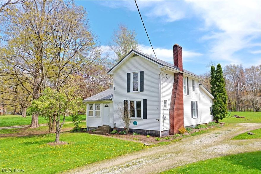 Scenic country style living two-bedroom farmhouse style home! Featuring a large lot with a huge backyard and tons of clean-living space with gorgeous hardwood flooring, this Bristolville residence holds plenty of potential inside and out. A long gravel drive features a turnaround for ease of access as you make your way past the rear breezeway. The formal entry has a sunroom before a secondary door reveals the newly carpeted living room, all trimmed with stained wood paneling. Sculpted archways transition into the adjacent kitchen and family rooms. The pass-through family room showcases a brick fireplace (condition unknown), centered on the wood accent wall. Formal dining bridges both it and the kitchen while a full bath breaks off with tiled flooring. Enjoy the robust kitchen as multiple countertops span each wall; joined by plenty of cabinet space. First floor laundry is located before basement access. Up the carpeted stairway, the two second floor bedrooms are spacious with large closets. Call today for more!