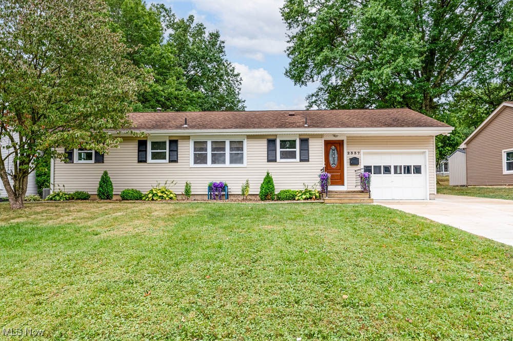 Step inside this beautifully updated 3-bedroom ranch and fall in love with its charm and comfort. The spacious living room welcomes you with refinished original hardwood floors and newer patio doors, filling the home with natural light. The updated kitchen is a showstopper, featuring newer cabinets with soft-close drawers, a subway tile backsplash, sleek countertops, laminate flooring, and a generous eat-in area—plus all stainless steel appliances are included. The bathroom boasts dual vanities, a stunning tiled tub surround, and stylish tile flooring. Throughout the home, you’ll appreciate the newer interior doors and modern light fixtures. Major updates give peace of mind, including a newer furnace and central air, updated electric panel, energy-efficient windows, siding, gutters, and downspouts (all replaced in 2018), plus a newer roof (2008) and hot water tank (2013).
The lower level offers a large, open basement—perfect for a media room, family room, or home gym. Outside, you’ll love the extended concrete driveway (2024), oversized fenced backyard, and a huge 20x20 deck with hot tub (2022)—ideal for entertaining or unwinding. Updated drainage system with French drains installed in 2020. An attached one-car garage and a spacious storage shed complete the package. Don’t miss your chance to make this move-in ready gem yours!
