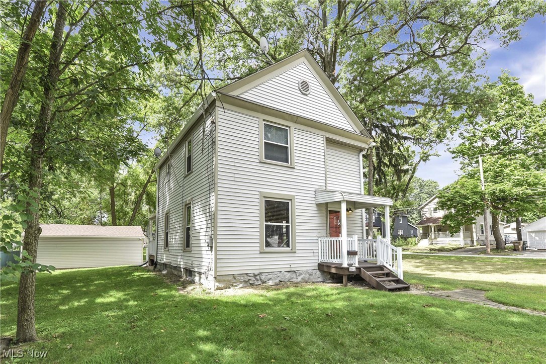 Be a part of Cuyahoga Falls history! Built in the pre-1900s by The Ohio Historical Center and originally a farmhouse. Many changes to the colonial over the years. Main floor converted to "OPEN" Great Room with first floor updated full bath and added newer washer and dryer. Kitchen updated with white cabinetry, granite countertops, stainless appliances and newer flooring throughout. Upstairs 3 bedrooms with updated full bath. Beautiful natural woodwork can be found on both floors. Seller has done roof maintenance and replaced gutters to 5", re-graded driveway with stone and around perimeter of garage. Basement preventative measure 15 yr dry lock and under both porches resealed with masonry pointing. Sit back and relax in this .56 acre around the fire pit and enjoy the seasons!