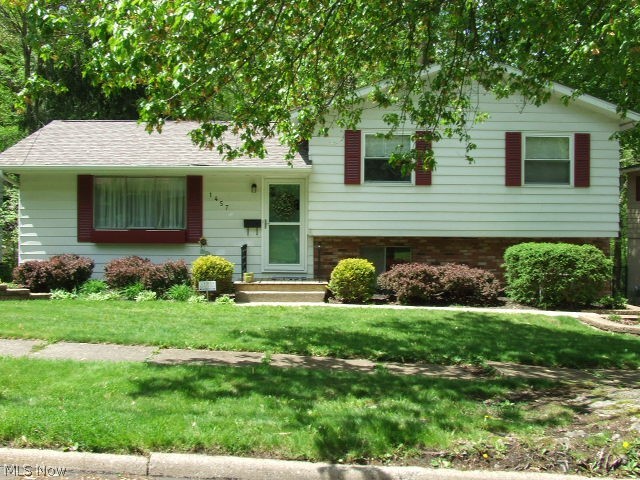 West Akron Split Level overlooks Metro park! Updated kitchen with Clearwater filtration system, breakfast bar and maple cabinets. Appliances stay. Great room features a cathedral, beamed ceiling and newer carpet (2 years old). Upstairs three bedrooms share a fully updated bath with cultured marble and set temperature shower. The lower level features a family room with a gas corner fireplace and built-in cabinetry. Walk out to a deck with stunning views of the metro park. A laundry/utility room and updated half bath complete the lower level with walk-out to garage. Washer and dryer negotiable. Make an appointment for a private showing today. Home Warranty included!