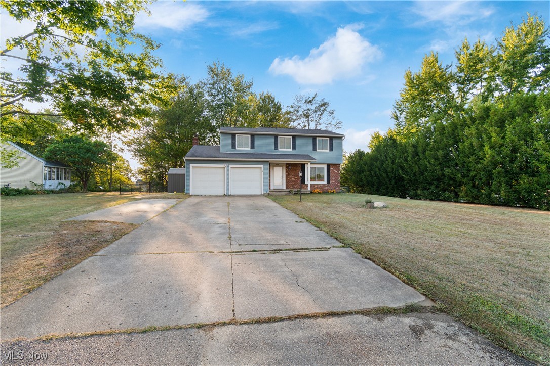 This four bedroom colonial in Green schools has been tastefully updated and is ready for new ownership! Upon entering the home, you are instantly greeted with natural lighting and a warm, inviting floor plan with LVT flooring throughout most of the main level. The living room flows seamlessly into the large dining room, eat-in the kitchen and family room with a custom fireplace. Sliding doors lead outside to your covered back porch on a large lot with a fenced in backyard. The perfect place to entertain! There is a half bathroom near the attached garage for convenience. Upstairs are all four bedrooms and an updated full bathroom. The primary and fourth bedroom features new LVT flooring. Neutral paint throughout. The basement awaits your creativity and provides a laundry area, stand up shower and plenty of storage. Stainless steel appliances, washer and dryer convey! There is a large cement driveway for additional parking and storage shed to store your items out of the elements. With close proximity to schools, parks, restaurants and more, this is a property you will feel PROUD to call home! Schedule your showing today as this one will not last!