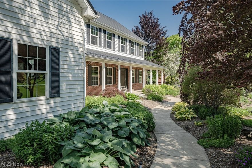 Amazing opportunity for a very spacious contemporary colonial on a tranquil 0.89 acre lot in Valley City! This impressive home features 5,494 square feet of living space with 7 bedrooms, 4 full bathrooms, 2 half baths, spacious living areas, a fully finished walk-out lower level, stunning landscaping, and so much more. The front door opens from the front porch into a welcoming foyer with two sets of french doors - one to a sitting room and the other to an office. Head back to the fantastic living room that boasts soaring 2-story ceilings with skylights, a wood-burning fireplace, and gleaming hardwood flooring. The adjacent kitchen includes a full complement of newer stainless steel appliances, plenty of cabinet space, and dining area with deck access. There are three generously-sized bedrooms on the first floor, as well as a full bathroom, a laundry room, and a convenient half bath off of the kitchen. Upstairs, there are three bedrooms including the primary suite that features a walk-in closet, an ensuite full bath with a clawfoot tub, and a spacious bedroom with a fireplace. The expansive, fully-finished lower level can be used as a separate living suite with a large rec room / living room, a kitchen, a bedroom with an ensuite full bath, and a laundry room. Plus, there are two sizable bonus rooms that could also be used as bedrooms. The attached 3-car garage features an automotive lift, storage, and a finished flex space above the garage that includes a half bath. Outside, there are two ponds, a wrap-around back deck, a hot tub, a chicken coop, and a greenhouse with gas and electrical service. Plus a detached 2-level garage includes a catering space up top with driveway access, and a lower level with a door to the back yard - perfect for all your lawn equipment! Fantastic location just minutes away from Brunswick town center and highway access. Don't miss this one!