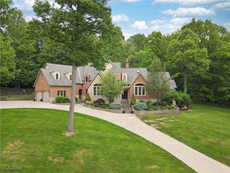 Custom built brick and stone Country French home on a quiet treed nearly 3 acre lot. Walking up to this gracious home, a spacious foyer welcomes you to the two story great room with a view of the private yard, two story fireplace, and room for custom built-ins. The gourmet kitchen has rich maple wood cabinets, with many extra unique storage spaces, a coffee bar, breakfast bar, pantry and dining area. There is a vaulted dining room, half bath, laundry room with built-ins also on the main floor.  The first  floor private owners suite overlooks the wooded yard, has a sitting area, walk in closet, and good size bath with a barrel ceiling.  
Three nice sized bedrooms, a reading nook, and a great room are on the second floor, each with their own full bath.  
The walk out lower level is ready to be finished-plumbed for a kitchen and bath, and access to the garages. There is a half bath off the rear patio for easy children and guest access.
The quality of this fine home boasts real stone on the exterior, maple wood trim and cabinetry, Brazilian cherry wood floors, transom windows and more. 
Seller prefers day before notice to show.