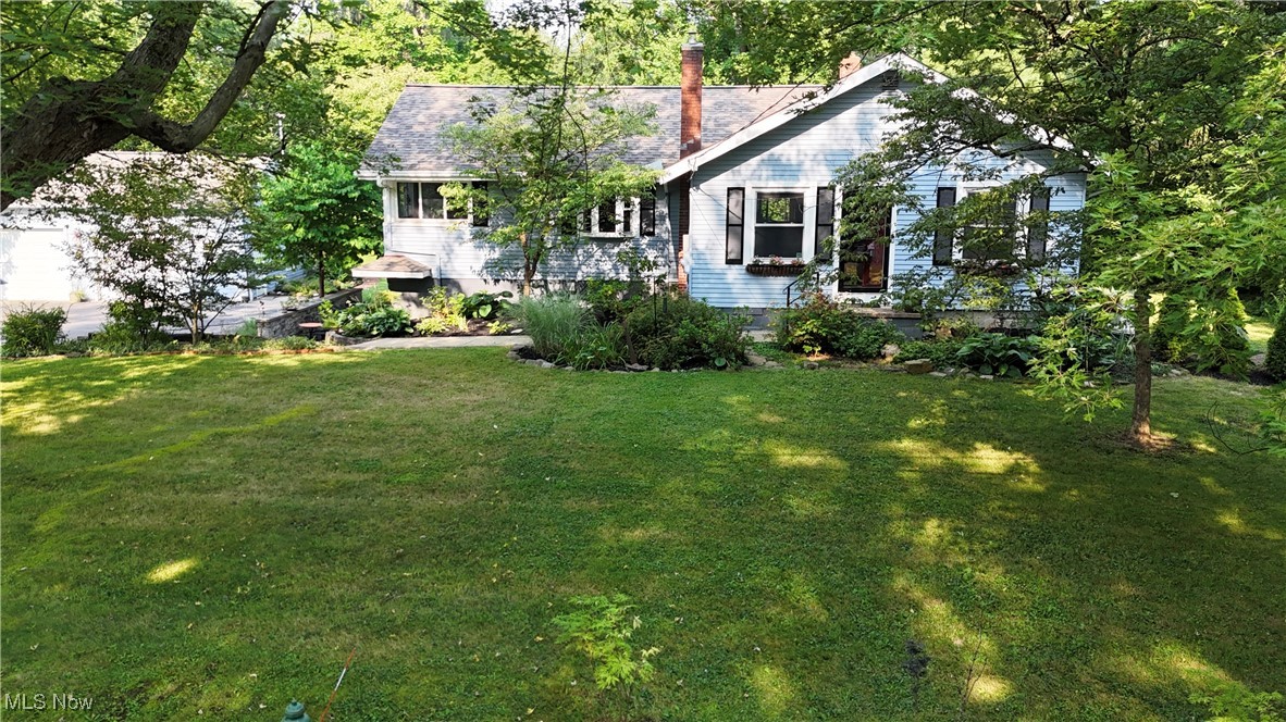 This renovated 3 bedroom and 2 full bath ranch sits on almost an acre lot with a gorgeous country setting. The finished lower level walks out to a patio and yard with a two story shed and attached greenhouse. The oversized garage has a great workshop and provides incredible storage space as well. Pride of ownership abounds with the list of major improvements in the last five years. From the new master bathroom to the electrical and waterproofing complete overhaul, the house is loaded with charm and updated in every way. Walk into the living room with refinished original hardwood floors, a newer wood burning, Regency fireplace insert flanked by built in bookshelves. The kitchen has a long live edge wood breakfast counter with stools as well as an island. The kitchen has sliders to the screened porch with a new vaulted ceiling and skylight to keep the kitchen sunny and adding so much living space for most of the year. The oversized dining room doubles as a workspace or reading corner surrounded by windows. The primary bedroom is off the dining room with a gorgeous bathroom and barn doors for privacy and for the closet. The other two bedrooms are off the other side of the living room hallway and share the other bathroom that is updated with so much personality! At the open stairscase to the lower level off the kitchen also has an entry door to the backyard. The lower level family room is spacious, bright and was completely remodeled with a gas fireplace too. The laundry is in the unfinished part of the basement and a private office was added as well. The house, shed & garage were recently painted and all new tear off roofs were replaced as well as a totally replaced asphalt driveway and Leaf Guard gutter system! Just move in to this adorable home in the award winning Orange school district! Seller is offering a home warranty, square footage is approximate.