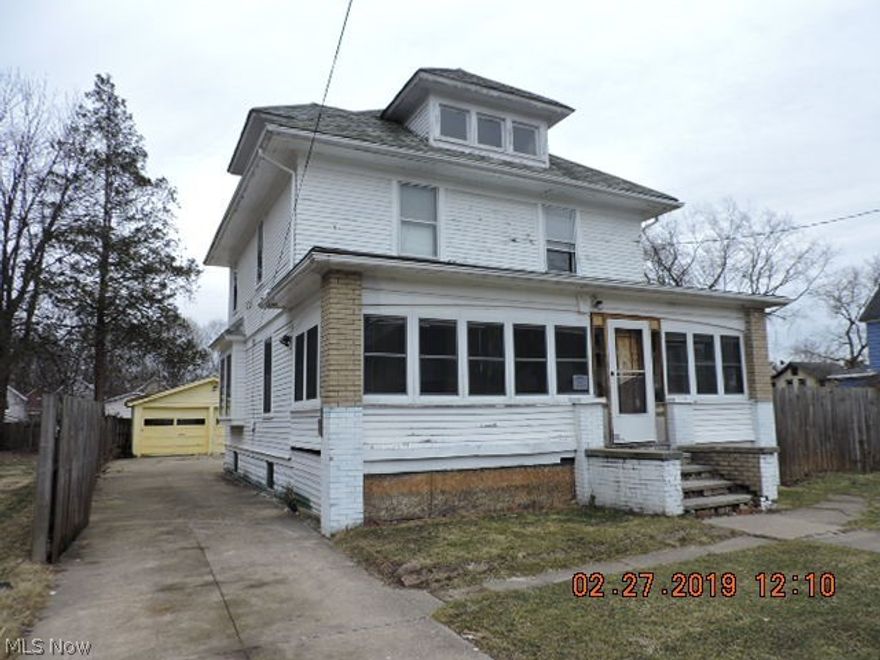 Don't let the outside fool you!  Need a huge 2+ car garage and extra parking?  THIS IS IT!   FABULOUS original woodwork and columns adorn the living room and dining room of this 2 and a half story fixer upper.  The kitchen has older but good updated cabinets and countertops.  The huge bath has a re-envisioned vanity and an updated tub with a tiled surround and newer plumbing.  Recently lived in, all utilities were in working condition as of February 5th.  The attic is finishable and has been finished in the past.  There are 2 basement rooms aside from the large main room with the utilities and laundry area. Topping it all off are a large enclosed front porch, a smaller unfinished back porch, a paved driveway, a huge 2 car garage, and a completely fenced in back yard.  Buyer must pay the $150 listing agency management fee.  SEE WHAT YOU CAN DO WITH THIS!