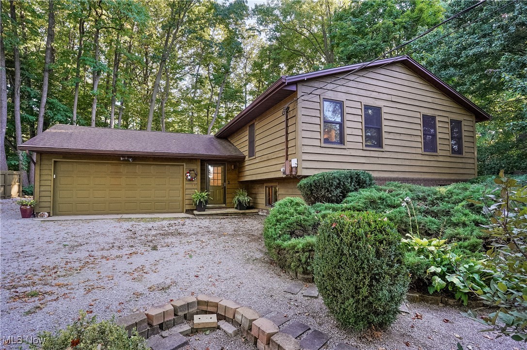 WELCOME TO YOUR PRIVATE RETREAT IN CONCORD! This well-maintained, home is nestled on a peaceful 1-acre lot, offering the perfect balance of space, comfort, and versatility. The home opens with a spacious foyer that leads up to a bright, inviting living room overlooking the wooded backyard. The custom kitchen is designed for both style and function, featuring solid wood cabinetry, a double oven, and a cozy dining area. From here, step into the three-season room—an ideal spot for enjoying morning coffee, reading, or relaxing with friends while taking in the natural views. The main level includes three comfortable bedrooms and two full baths, including a primary suite with its own private bath. A thoughtful first-floor addition expands the living options, offering high ceilings, skylights, and access to a covered patio. This flexible space can serve as an in-law suite, exercise studio, home office, or playroom to fit your needs. The lower level adds even more living space with a welcoming family room and a wood-burning fireplace, along with an additional bedroom, full bath, and laundry room. Throughout the home, you’ll find peace of mind in the many updates, including newer windows, doors, and heating/cooling systems. Your private, wooded back yard features a covered patio, hot tub, walking path and the peaceful tranquility of enjoying nature. With multiple gathering areas, generous storage, and flexible living spaces, this home is perfect for entertaining, multi-generational living, or simply enjoying the quiet of its private setting.