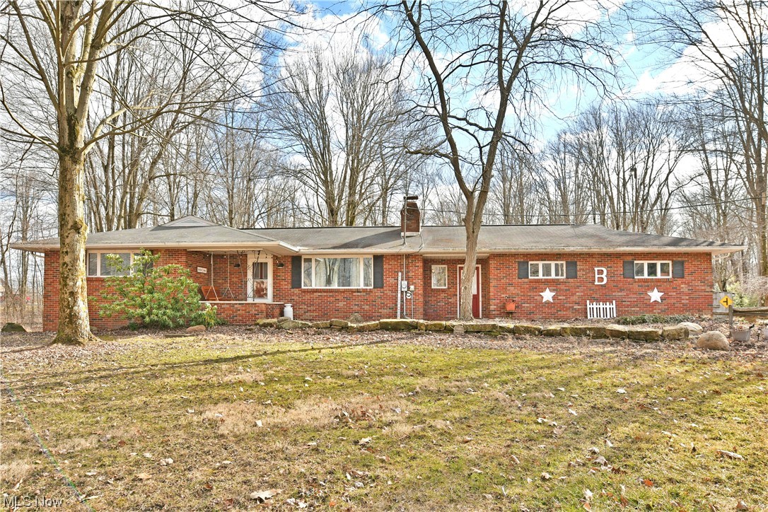 Sit on the front porch swing soaking up the country paradise. A Well maintained Brick Ranch on 5.69 mostly wooded acres in Maplewood Schools is a Dream Come True. Sat far off the road, the home captivates the eye with the beautiful landscaping, winding creek throughout the property, concrete driveway and attached garage. A newly renovated breezeway flows into the kitchen that is boasting with natural light. Newer neutral colored carpet throughout, the living room presents with a beautiful stone fireplace. All 3 bed rooms on the first floor with a half bath attached to the master bedroom. The full basement has plenty of storage space, workout area, laundry room and options for additional living space. This home is a must see if you're tired of the hustle and bustle and ready for country living. Two storage outbuildings also available on this wooded lot, one being a two story "she shed".