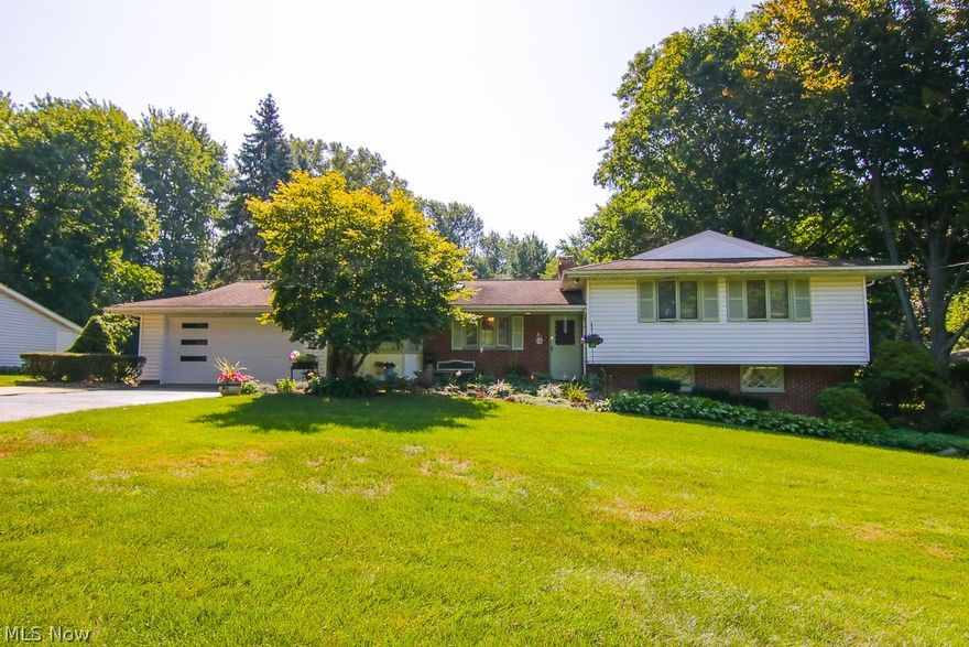 Create new memories in this lovely 4 Bedroom, 2.5 Bath Split Level Home that includes a Galley style Stainless Steel Kitchen, skylight, and bay window style breakfast area.  The Living Room/Dining Room combination has a wood burning stove insert and a wall of windows looking on to a large private wooded lot.  Spend cozy winter evenings in the lower level 15x22 ft. Family Room enjoying the fire in the wood burning fireplace.  Entertain your guests on the adjacent private concrete patio with a built in natural gas grill.  This home has good storage, lots of large windows affording great light and cross breezes for pleasant night time sleeping.  This home comes with a one year home warranty.  LOCATION, LOCATION, LOCATION!  Close to shopping, schools, restaurants, parks, and freeways, yet in a quiet neighborhood.