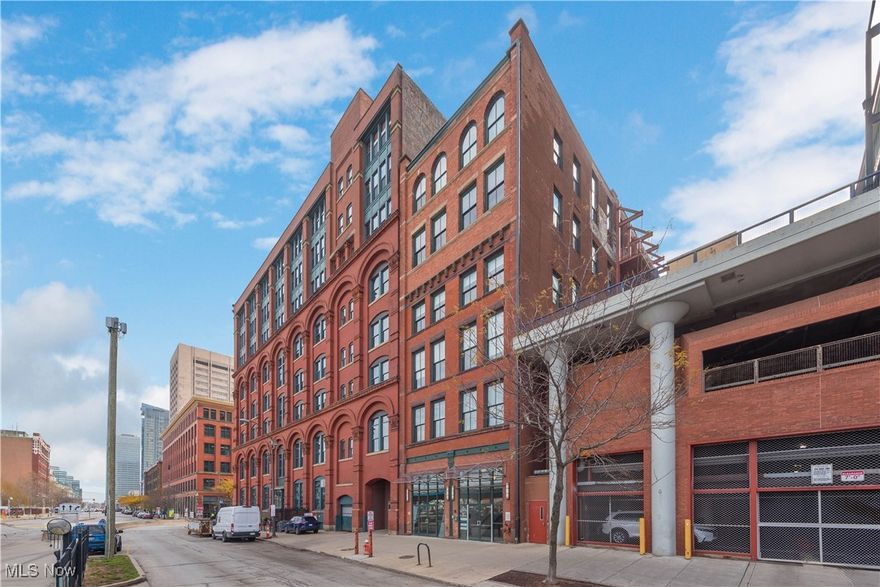 Experience the best of downtown living in this stunning two-level penthouse condominium nestled in Cleveland’s vibrant Warehouse District. Thoughtfully renovated and impeccably maintained, this exceptional home checks every box—garage parking, tax abatement through 2026, in-unit laundry, and a long list of stylish upgrades. Step inside to a generous foyer with uncommon storage space rarely found in downtown residences. Upstairs, an open and airy layout unfolds with a bright living and dining area, an updated kitchen, a spacious bedroom, a full bath, and an additional loft space ideal for an office, reading nook, or creative studio. Soaring ceilings, refinished hardwood floors, and exposed century-old brick create a warm, modern-industrial atmosphere. The expansive kitchen features a gas range with hood, Samsung stainless steel appliances, abundant cabinetry, and ample counter space—perfect for cooking… or for enjoying the endless array of acclaimed restaurants just steps from your building. The bedroom includes a custom Elfa closet system and convenient LG stackable washer and dryer. A beautifully updated bathroom showcases sleek flooring and dual sinks. The building’s impressive amenities elevate everyday living: a fully equipped fitness center, sauna, dog run, and a massive rooftop deck with panoramic city views. Set in an unbeatable location, this home is just a short walk to sports venues, the East Bank of the Flats, grocery stores, nightlife, and top-tier dining. If you’re seeking downtown convenience paired with comfort and character, this residence is an absolute must-see.