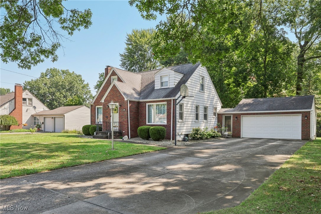 A remarkable Brick front, 2 story home, situated back on a deep lot with some gorgeous shade trees just enough to enjoy. This home sets back from the street quite aways, concrete drive widens to give excellent parking into a 2 car ample garage, then you access the kitchen from the enclosed and finished breezeway. The Living Room and Dining Room are open to each other and both have over sized picture windows flooding the living area with tons of light. Masonry fireplace with gorgeous Mantel in the living room, has the same brick that is on the exterior home. Newer flooring throughout. Nice sized eat in Kitchen with newer counter top and kitchen sink/faucet. Spacious Master Bedroom and 2 other large bedrooms. The bathroom has been updated and bright! Enclosed back porch and access to the garage. Deep beautiful lot with a Fire pit and shed. Landscaped nicely and the rear yard has a great area to do another sitting area with all new gravel. Many updates and great location close to Mill Creek Park.