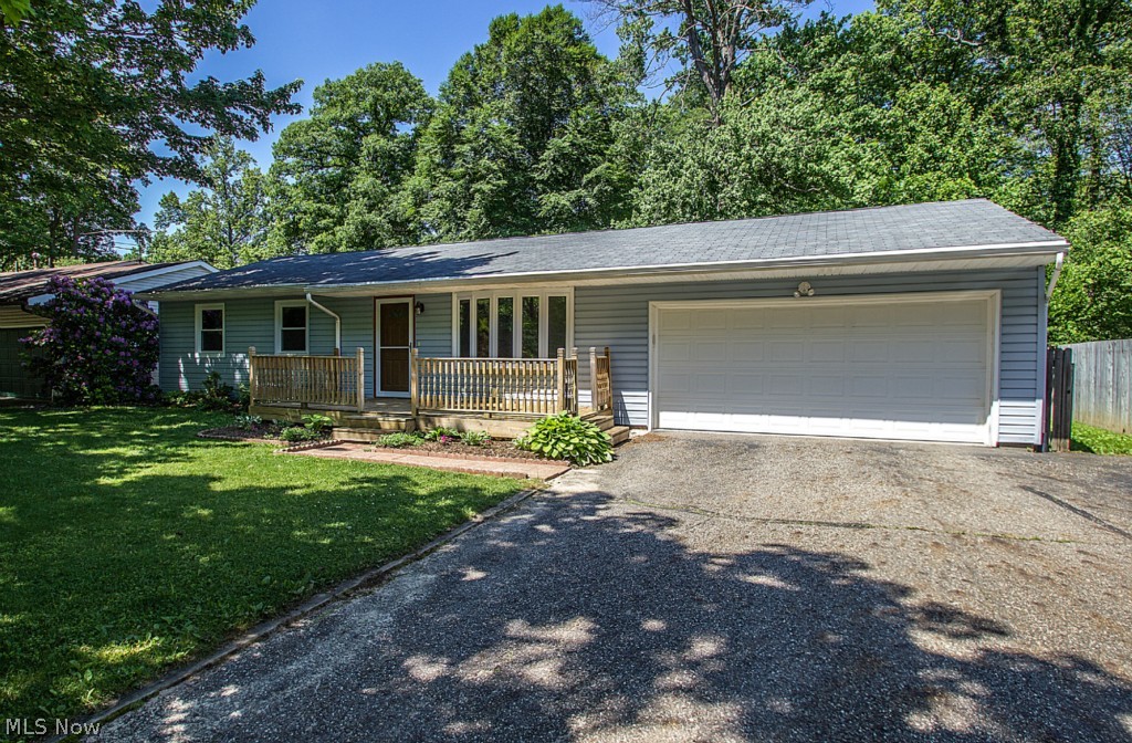 Welcome to this wonderful spacious ranch in Stow, near Indian Trail School. This home has an attached 2 car garage, has over 1500 finished SF when including finished basement plus 180SF sunroom! Drywall basement with new carpet, waterproofed in 2001 with warranty, replaced all windows in home, completely remodeled kitchen hickory oak cabinets, Corain counter-tops, breakfast bar, wine rack, newer appliances, ceramic tile floors! Roof 2006, gutters 2010, Furnace 2013, Hot water tank 2014, Master bath and shower remodeled in 2012. Living room with large bay window, backyard is very private, with wooded view, sunroom very nice during the summer. Wonderful front deck. This is a great home at a great price! Possible 4th bedroom in basement.
