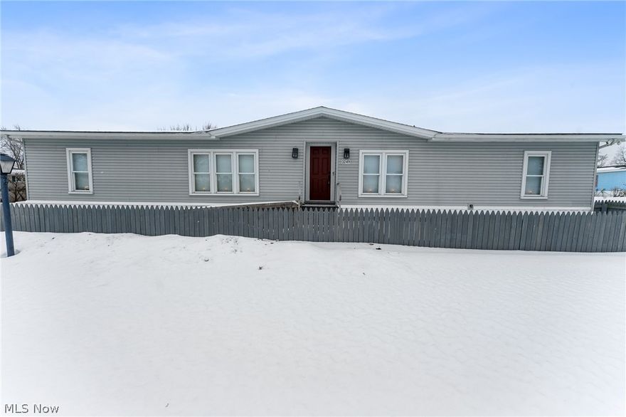 Welcome to this well-maintained manufactured home located in a desirable community offering comfort, space, and custom character throughout. Step inside to a large, vaulted living room with carpet that creates an open and inviting atmosphere. The kitchen features painted red cabinetry, laminate countertops, and ample cabinet storage, along with a dedicated dining area perfect for everyday living. The home offers a split-bedroom layout for added privacy, with the primary suite situated on one side featuring a walk-in closet and a custom rustic-designed full bathroom complete with a walk-in shower and custom vanity. On the opposite side of the home are two additional carpeted bedrooms with double closets and a second full bathroom showcasing a similar rustic design with tub surround and vanity. The main-floor laundry room provides convenient access to the backyard patio area and shed. The shed offers an enclosed storage section plus second-floor access for additional storage space. Additional features include furnace and central air, generator, vinyl siding, dimensional shingled roof, and a double concrete driveway. The current owner’s lot fee is 300 per month. Conveniently located near Lordstown and surrounding manufacturing facilities, this home offers an affordable opportunity in a great community setting.