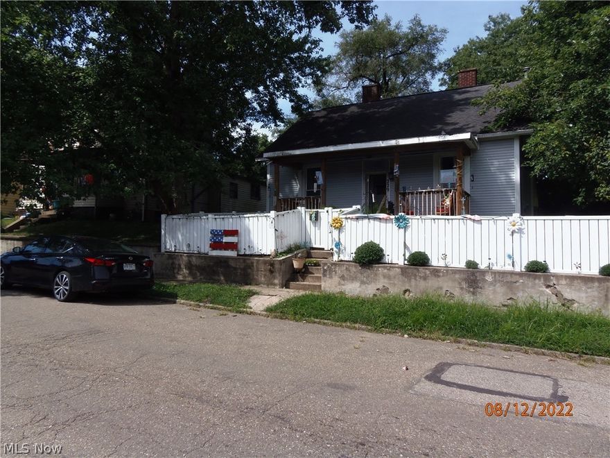 Cute bungalow that would make a great starter home for a reasonable price. Back porch has been enclosed and is wired for electricity, it only needs flooring, insulation and drywall to have yet another room that could be a bedroom, office, or sewing/craft room. Newer roof. Hot water heater replaced in 2021. Appliances negotiable. New electric wiring in the attic and some new plumbing has been run. Off street parking in rear with 1 car detached garage. Back yard is completely fenced to provide a nice play area for children or pets. However, fencing is unique and negotiable for purchase if buyer is interested. New flooring, paint, some new windows, and cabinets. Buyers beware Basement steps. Schedule a showing to see this home with tons of potential!