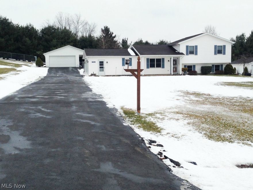 Country Setting with Conveniences of Town - Three Bedroom Home on Dead End Street with Attached and Detached Garages - Large Lot - Fenced Yard.  1,692 sq. ft. built in 1995.  Open living room, dining and oak kitchen with cathedral ceilings.  Three bedrooms and spacious full bath up, finished family room and den with kitchenette in basement.  Covered front porch, rear deck and fenced yard.  Attached insulated two car garage with propane heater.  20’ x 28’ Detached garage with drain, electric and covered porch.  Additional storage shed and black top drive.  City water and sewer.