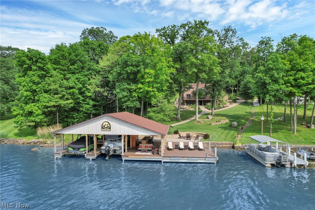 5000+/- sf home with 5 bedrooms, 3.5 bathrooms, full walk-out finished basement with second kitchen. 3 car attached garage. Don't miss out on this rare opportunity to own a one-of-a-kind LAKEFRONT home on private Apple Valley Lake! 127' of lake frontage and .8301 acres. Large boat house with huge dock area, bar, and 2 boat slips! Outdoor stone fireplace and stone fire ring at the water's edge. Enjoy stunning sunsets to the west and AVL members enjoy 3 beaches, jet skis, fishing & golfing out your doorstep! Annual taxes are approximately $16,120.96 and HOA is $250 per year. The seller is requiring the buyer to purchase the furnishings, equipment, and 2 boats as a turn-key package for an additional price. The home sleeps 13 and rents out for an average of $750 - $1000 per night on VRBO property #3815817.